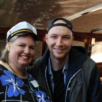 woman in captains hat with a different friend on boat